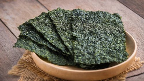 Crispy dried seaweed on wooden plate